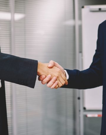 business-colleagues-shaking-hands-in-office-2025-03-26-21-57-22-utc