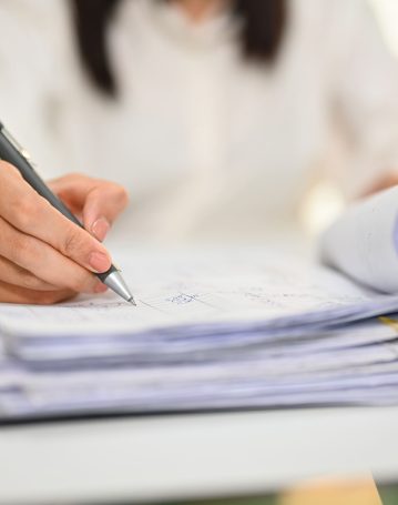 close-up-view-of-female-accountant-holding-pen-wri-2024-12-04-23-47-37-utc