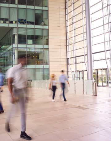 motion-blur-shot-of-businesspeople-in-lobby-of-bus-2024-10-19-07-32-30-utc